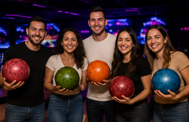 A group of friends holding colorful bowling balls together