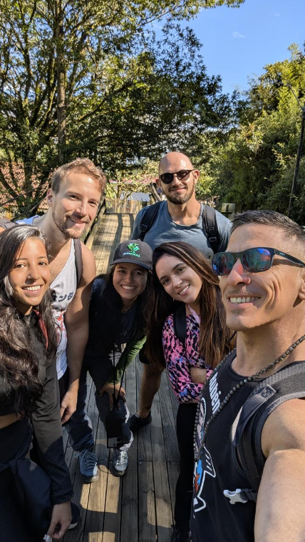 Friends from the Spanglish community smiling together after a hike