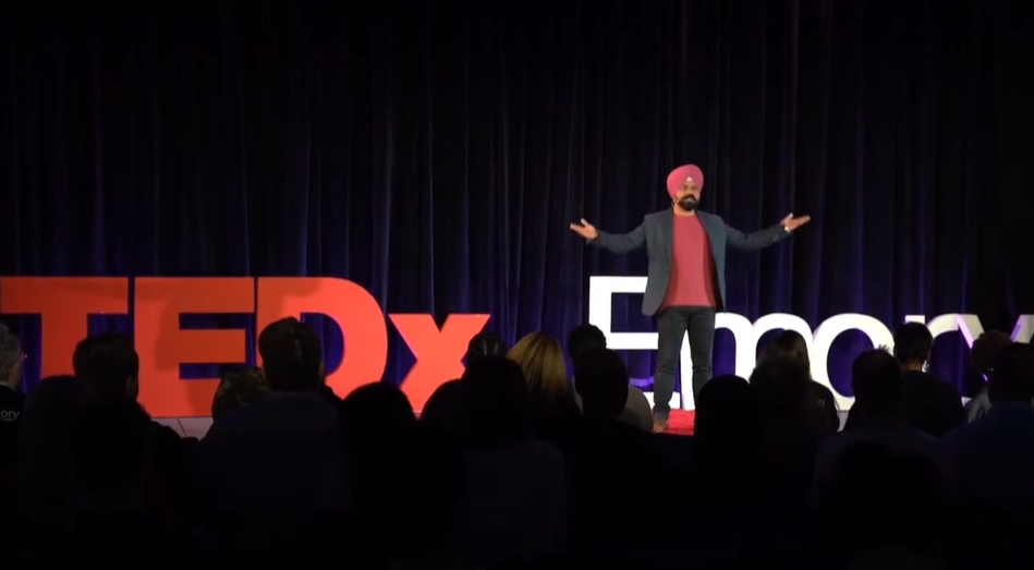 Roop Singh speaking on a TEDx stage